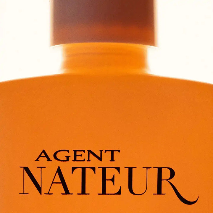 Orange bottle with ’Agent Nateur’ text on it.