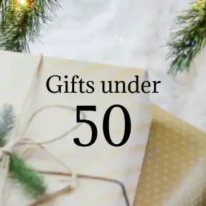 Text reading ’Gifts under 50’’ with evergreen branches visible around the edges.