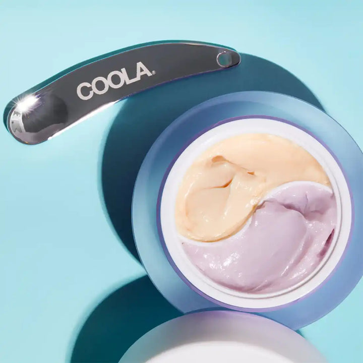 Two-toned ice cream or frozen dessert in a blue container with a ’Coola’ scoop.