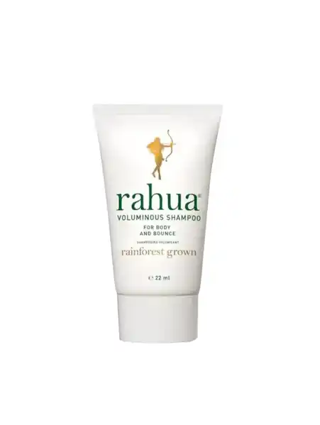 White tube of Rahua volumizing shampoo with green text and a gold archer logo.